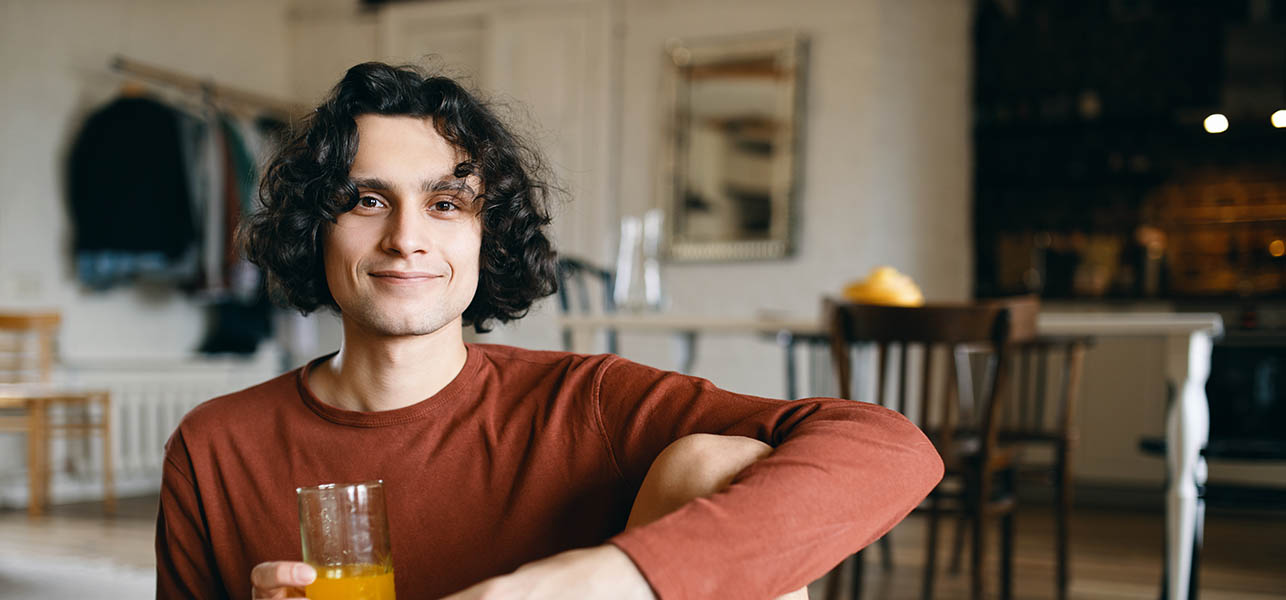 young man drinking juice.