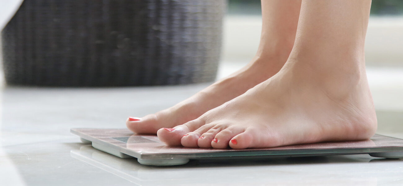 Woman standing on scales