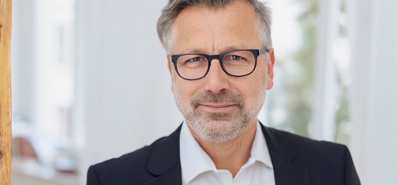 Middle aged man in glasses and formal outfit